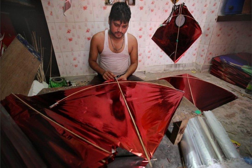 An Indian kite maker crafts kites ahead of the Independence Day celebrations, in New Delhi, India, 11 August 2016.