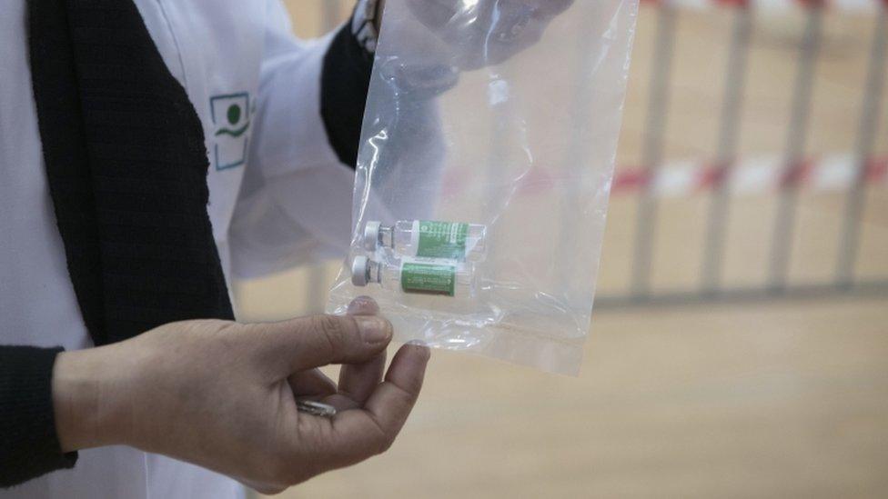 A health worker prepares to inject a first dose of a Oxford-AstraZeneca COVID-19 vaccine shot at a Covid-19 vaccination center in Rabat, Morocco