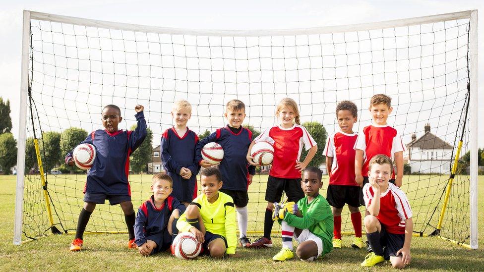 Football team standing in a goal