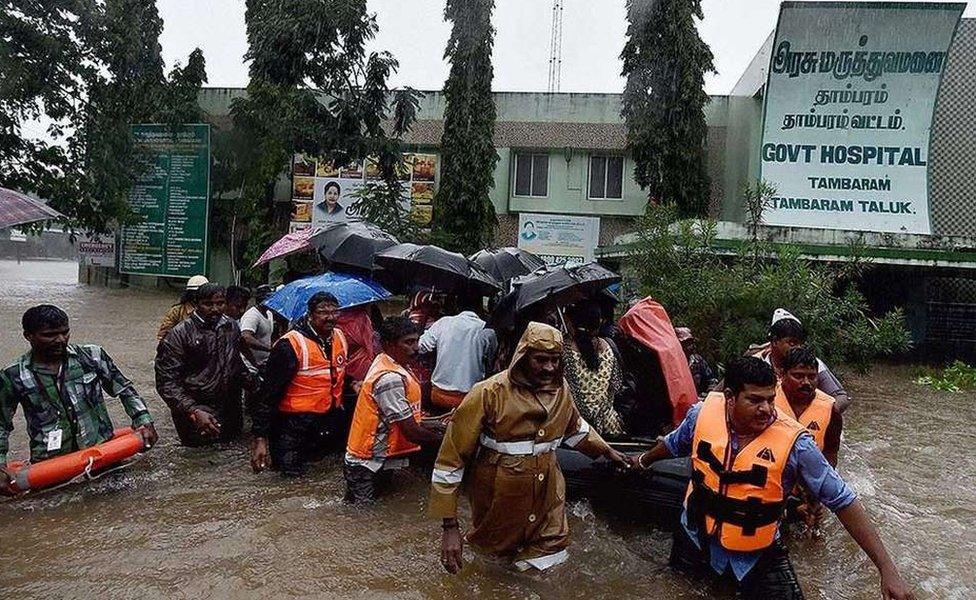 Rescuers shifting patients from a flooded hospital after heavy rains in Chennai.