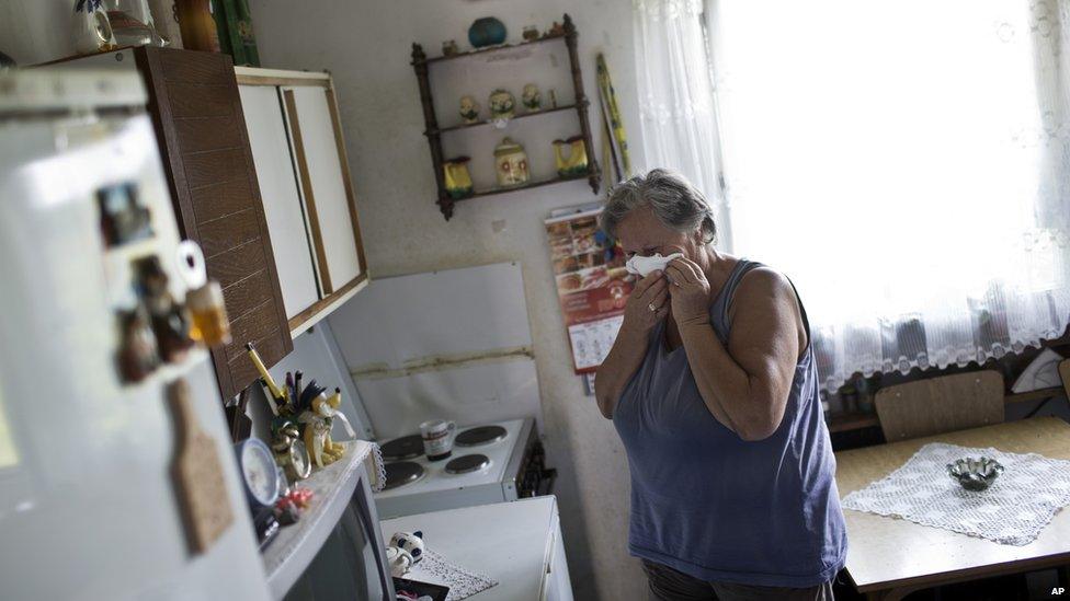 Dusanka Pjevalica, 69, a refugee from Croatia, sheds tears inside her home at a refugee centre in Belgrade, Serbia, Tuesday, 4 August 2015