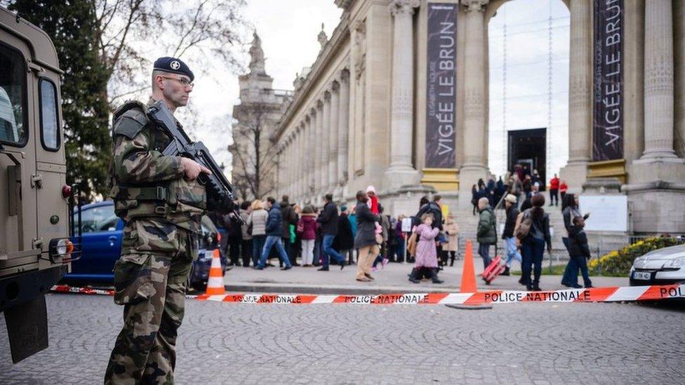 French soldiers patrol on the Avenue des Champs-Elysees in Paris