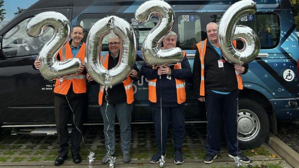 The DigiGo team holding celebratory 2026 balloons