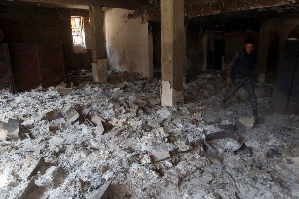 Burned ancient books and manuscripts are seen inside Mosul's heavily damaged museum (8 March 2017)