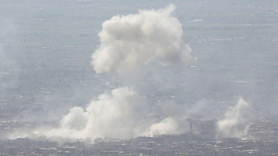 Smoke rises from Douma after a government air strike on 7 April 2018