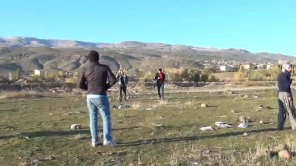 Locals scouring a field for meteorite pieces