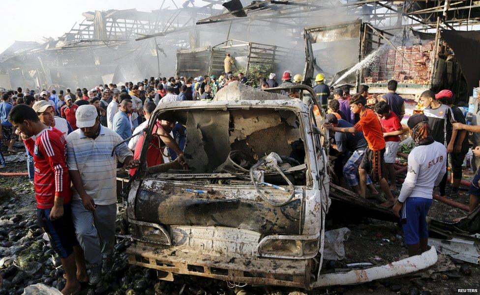 Residents gather at the site of a truck bomb attack at a crowded market in Baghdad ,August 13,2015.