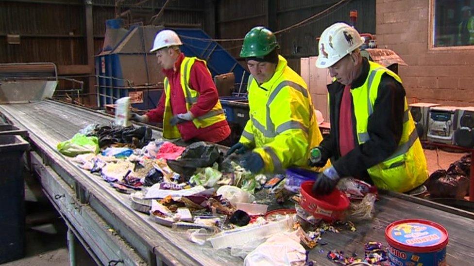 Workers sorting through recycling