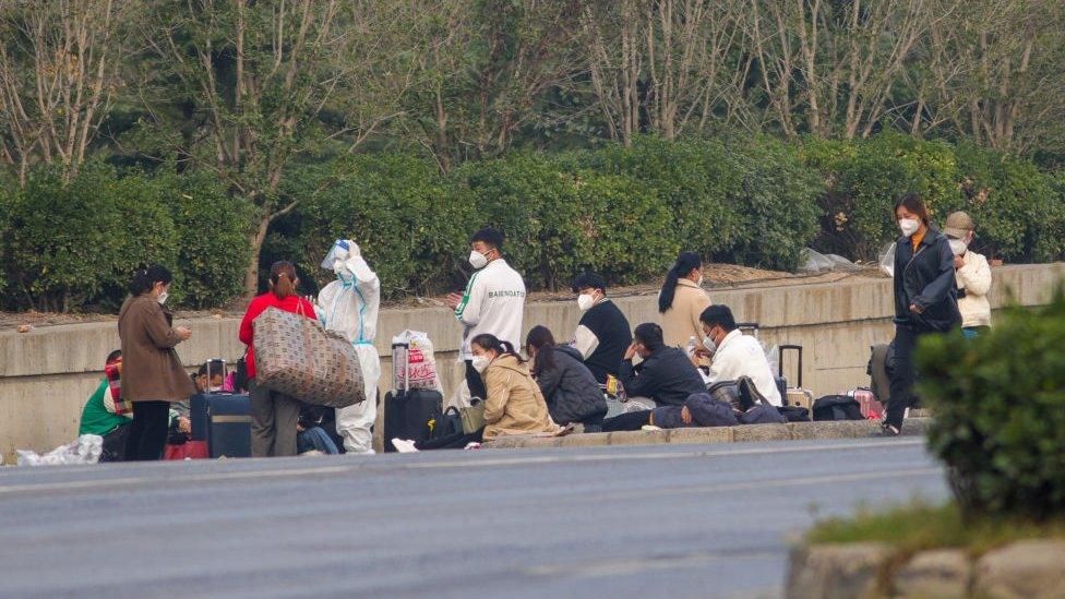 Foxconn employees wait to go home