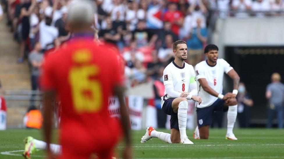 Jordan Henderson and Tyrone Mings taking a knee before England v Andorra