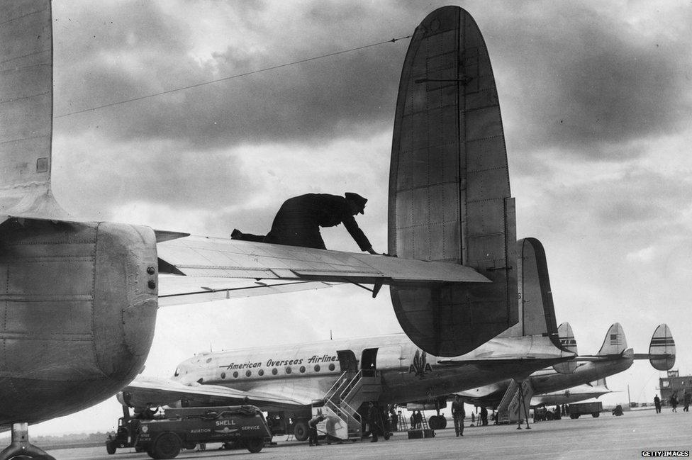 A scene at London Airport, Heathrow, one of the world's busiest airports. In the foreground a York bound for South Africa, and behind it American airliners being refuelled for their return journey to the United States, 1946