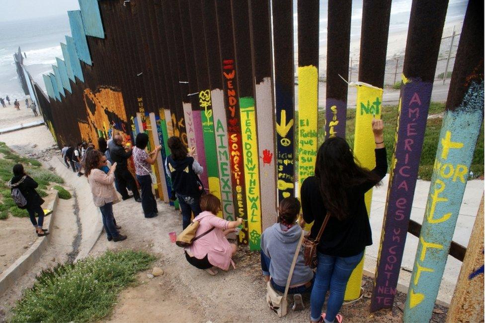 Mexican citizens paint on the border wall between Mexico and the United States in Tijuana, Mexico, 3 June 2017