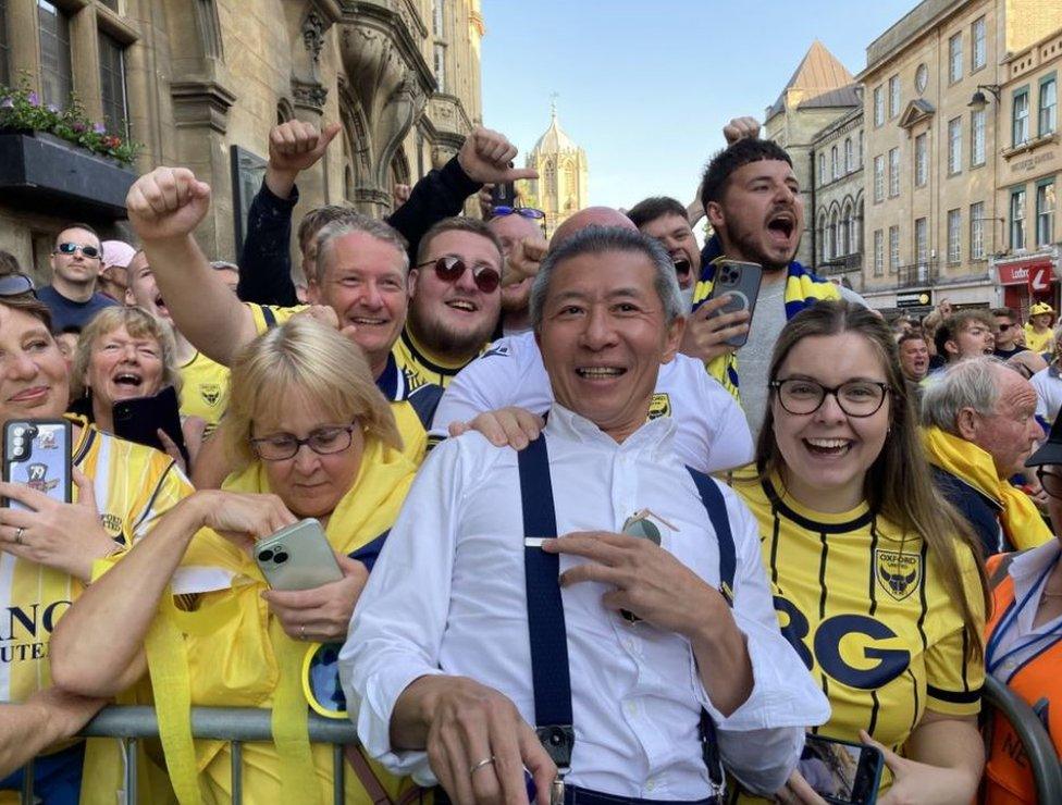 Fans gathered in the High Street wearing yellow Oxford United shirts