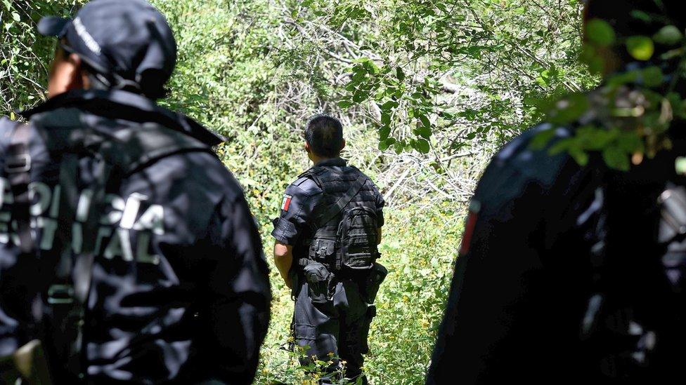 Police guard a mass grave outside Iguala. 9 Oct 2014