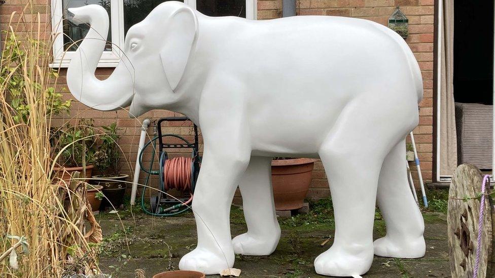 A white elephant statue that is set to be painted