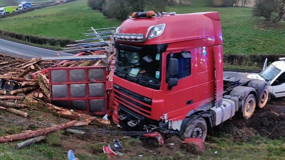 The overturned timber lorry