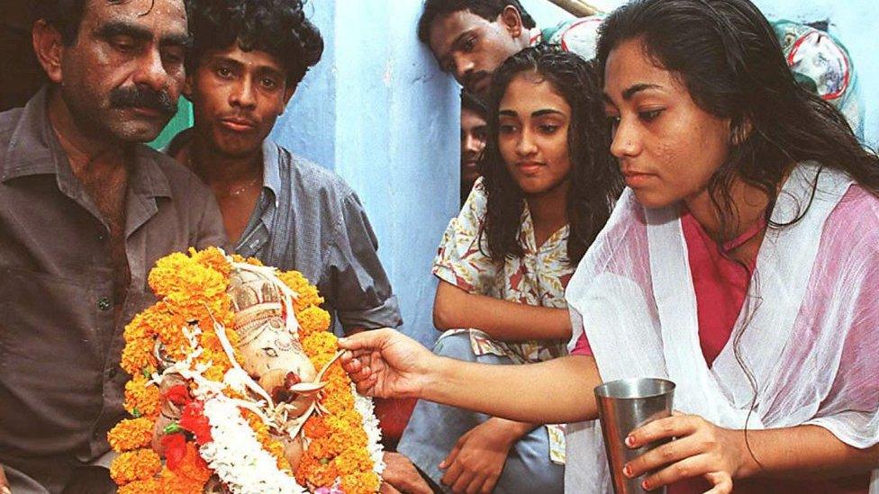 Hindus offering milk to Lord Ganesha