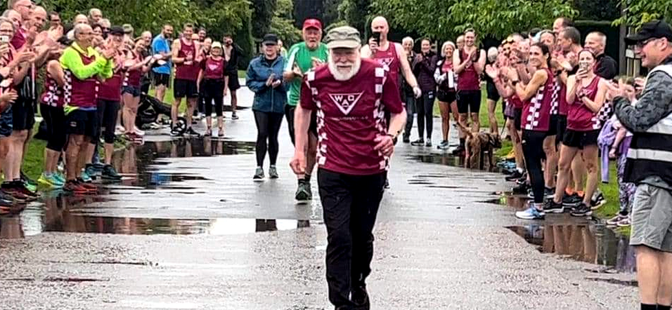 Rodney Freeburn taking part in Norwich Parkrun with members of Wymondham Athletics Club cheering him on