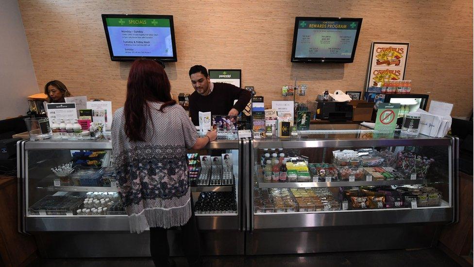 A customer is served at a cannabis shop in a medical dispensary in California