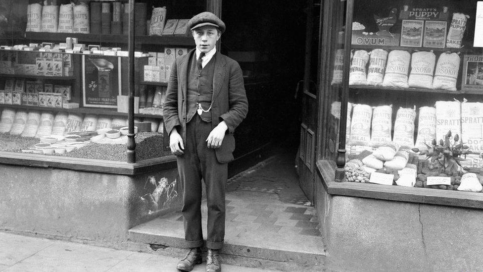 Black and white photo of Harold Jones outside his shop