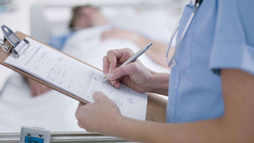 Nurse writing patient notes