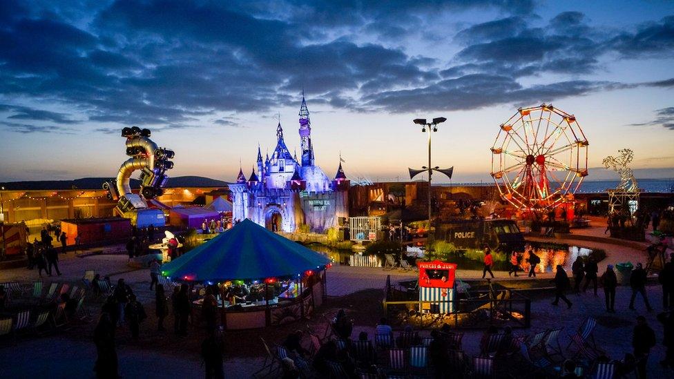 Banksy's Dismaland after sunset