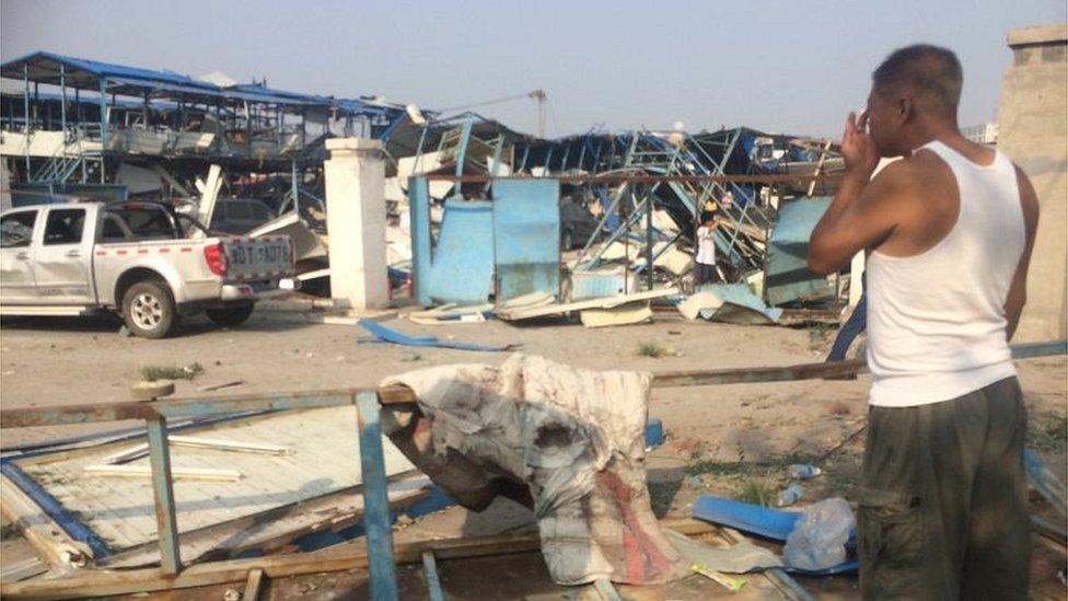 Man at the scene of a destroyed dormitory in Tianjin