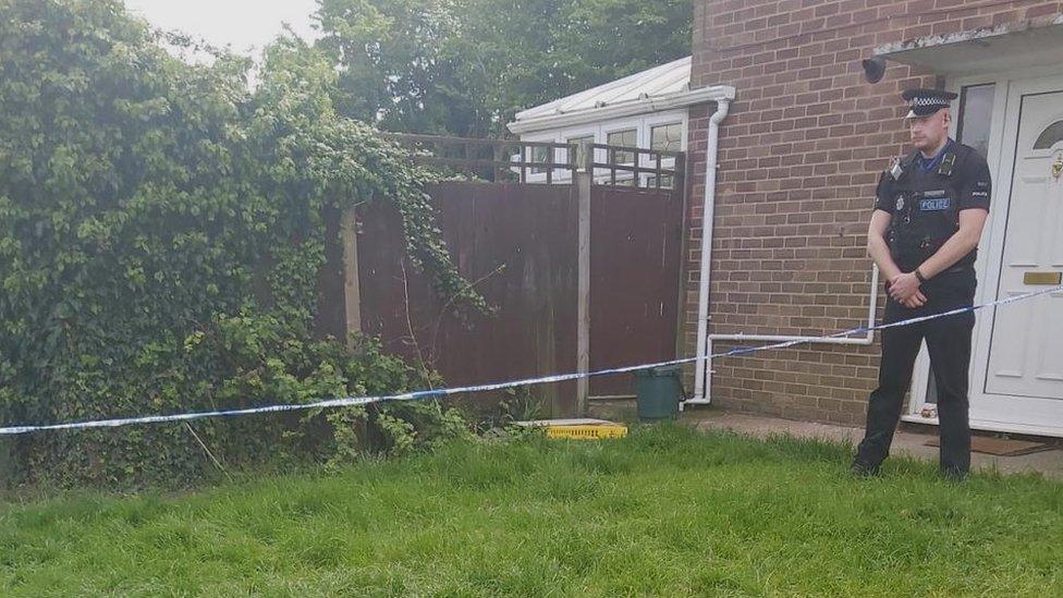 A police officer outside a house in Harlow, Essex