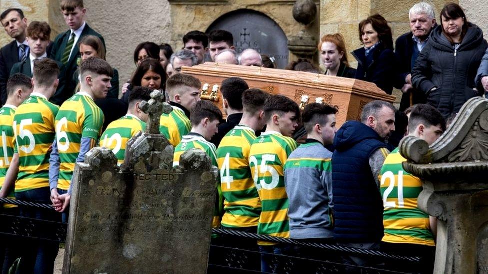 Members of St Malachy's Edendork GAC, who Connor Currie played for, flank his coffin