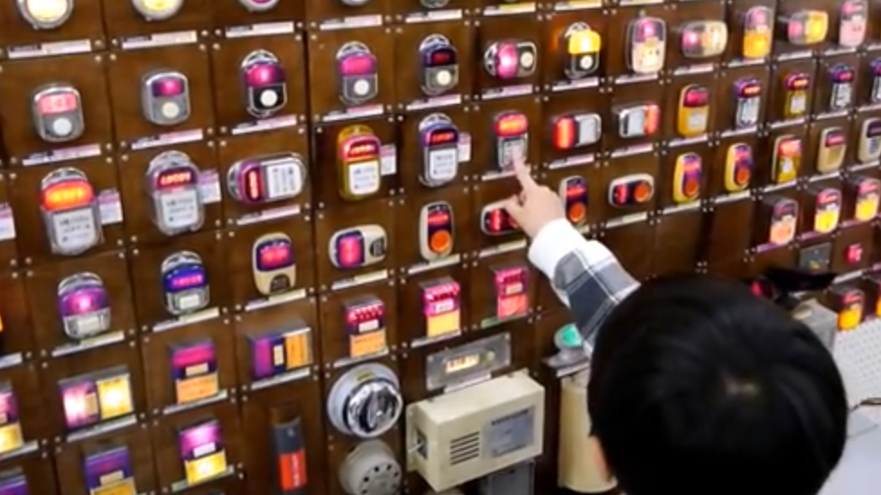 A child presses one of Mr Ishida's bus bells