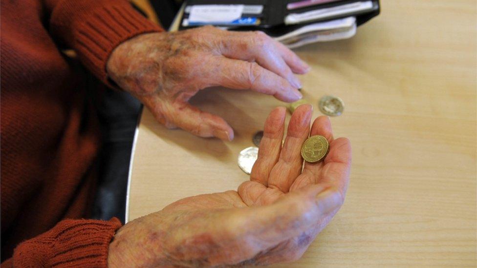 Pensioner's hands holding coins