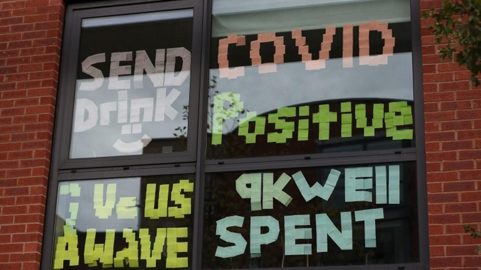 Signs on a window at Manchester Metropolitan University's Birley campus