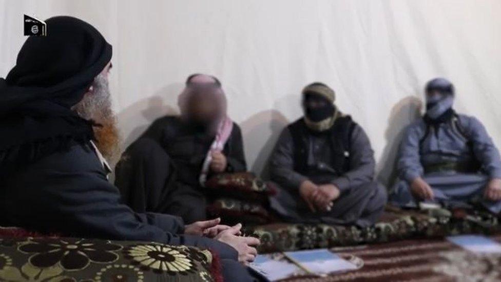 Abu Bakr al-Baghdadi (L) sits with fellow IS members