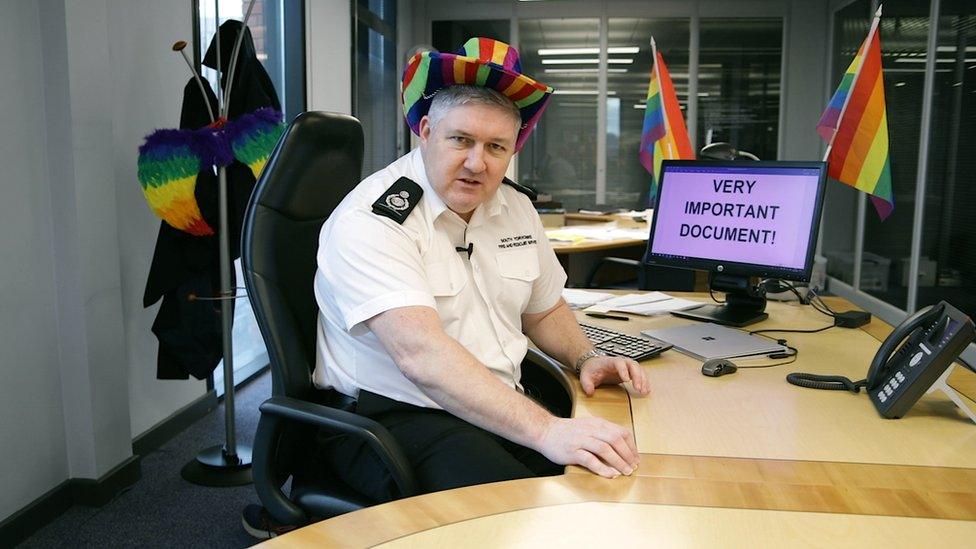 A still from the video showing a man in a rainbow hat