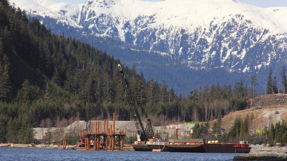 Cranes work in the water at the Kitimat LNG site near Kitimat, in northwestern British Columbia