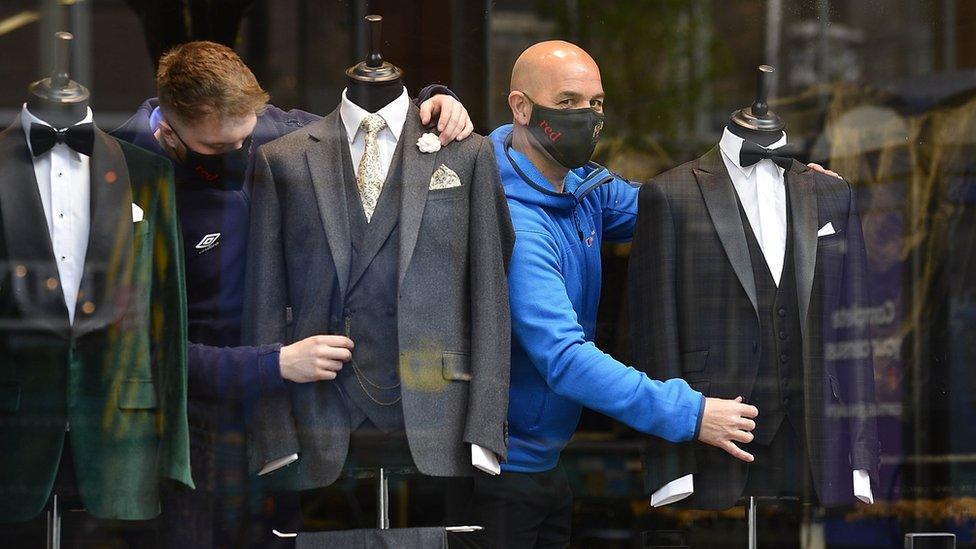 Shop attendants dress mannequins in Belfast suit shop