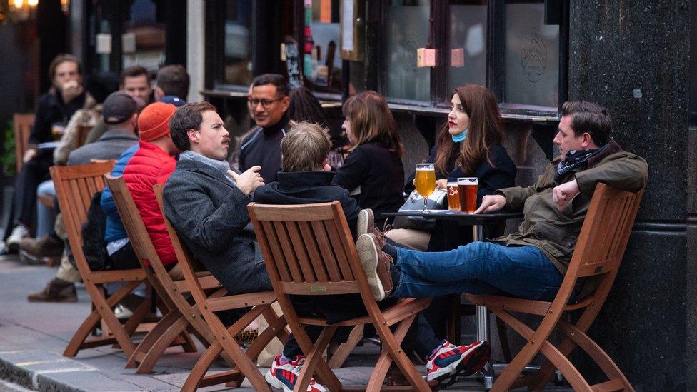 Photo dated 17 October 2020 of drinkers outside a pub in Soho, London, on the first day after the city was put into Tier 2 restrictions.