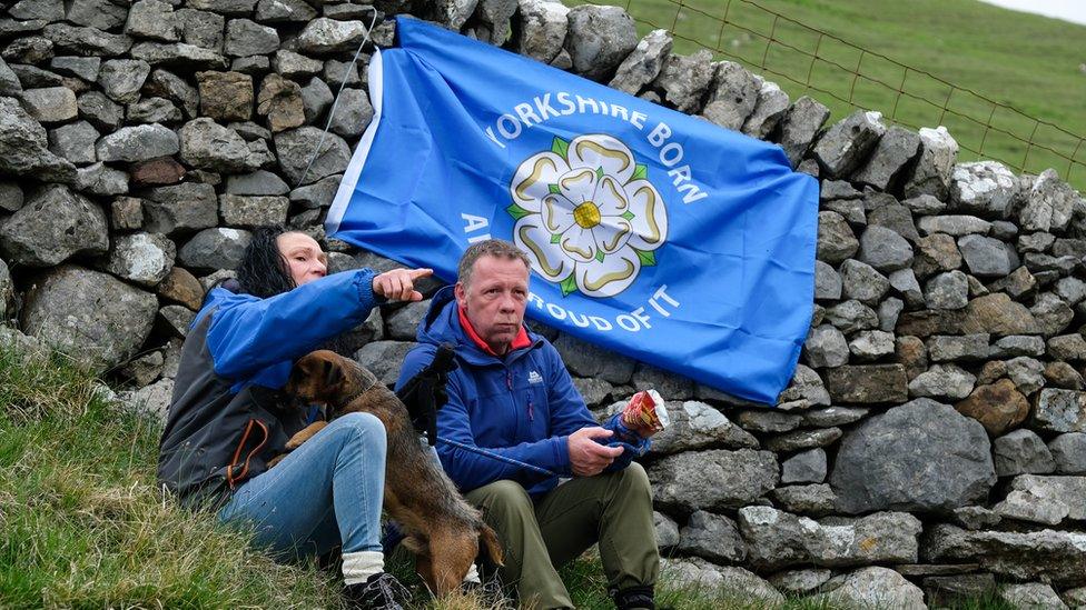 Yorkshire flag behind couple