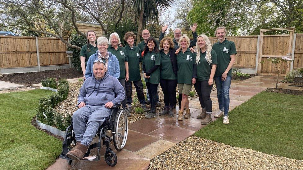 Adrian Waterhouse-Taylor in his Felixstowe garden with students and their tutor from Suffolk Rural College