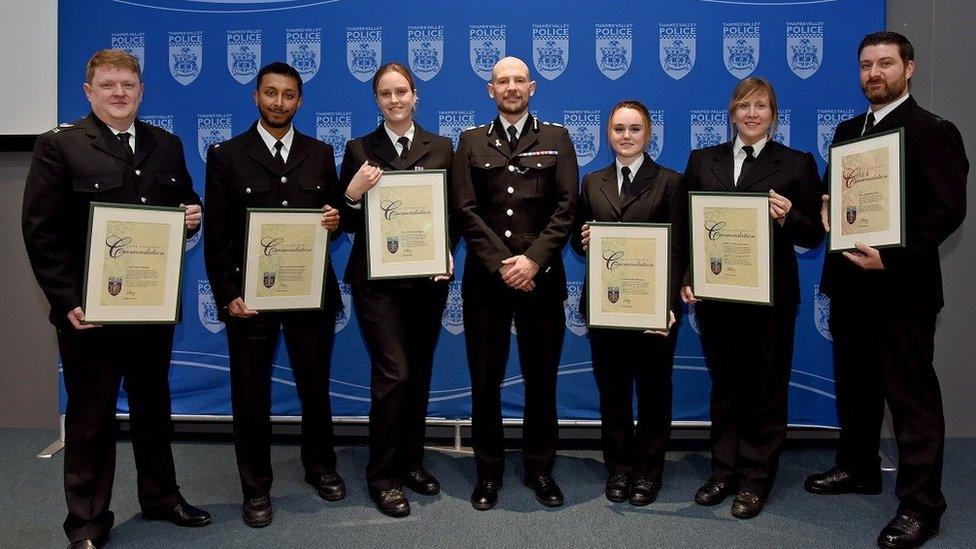 police officers holding certificates