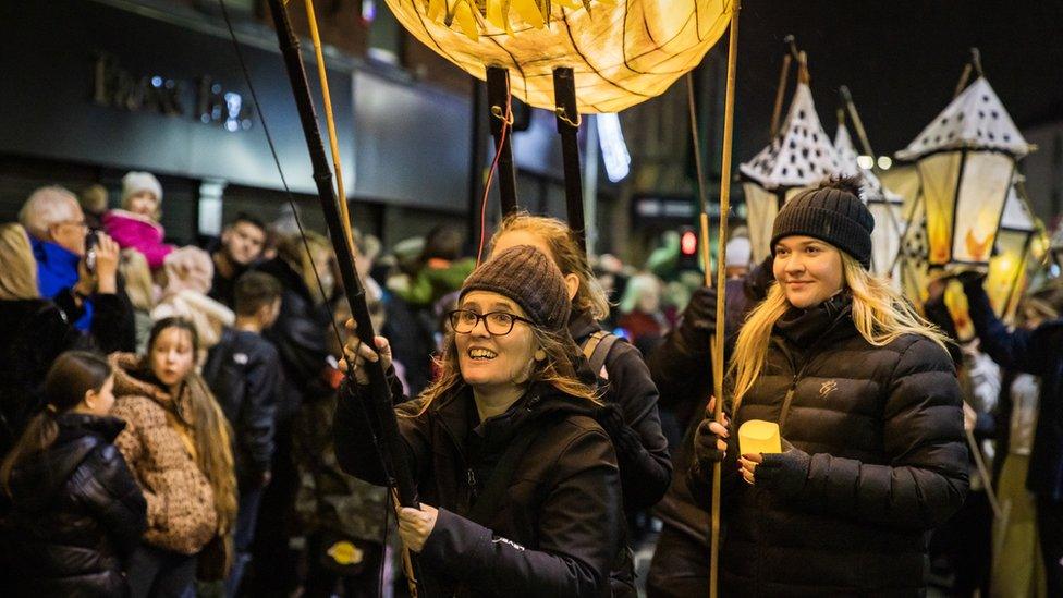 People taking part in light parade through town centre