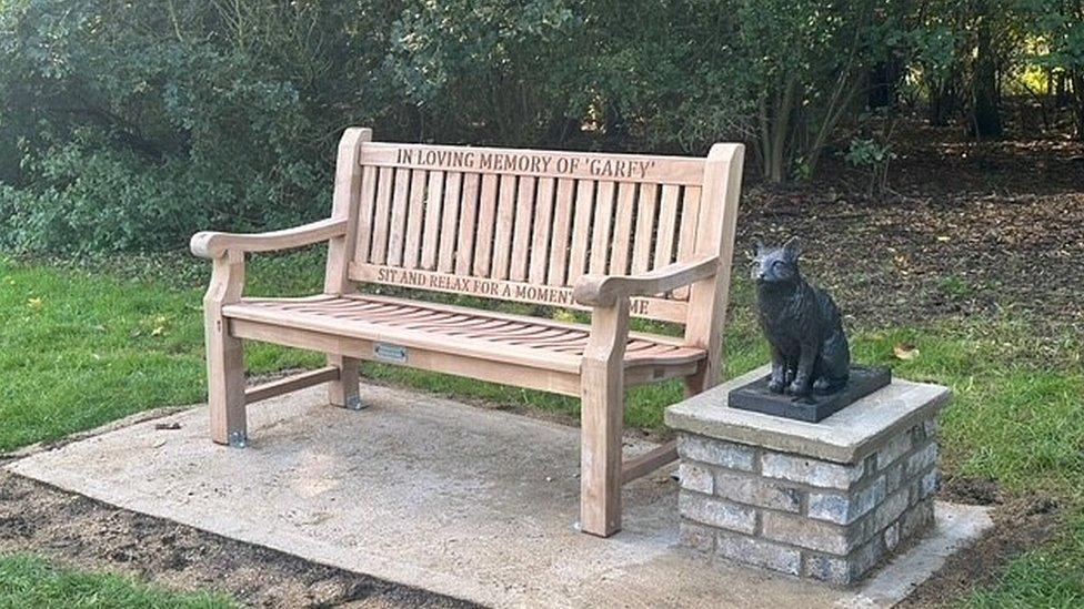 Bench and statue of cat