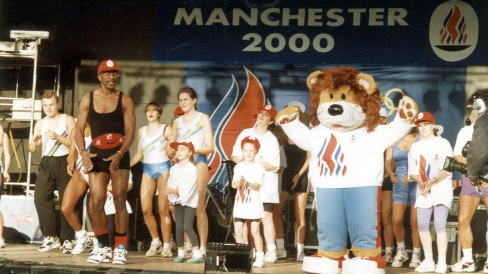 Mr Motivator, a mascot and some children on stage at an event in Manchester on the day in 1993 the 2000 Olympics host city was announced