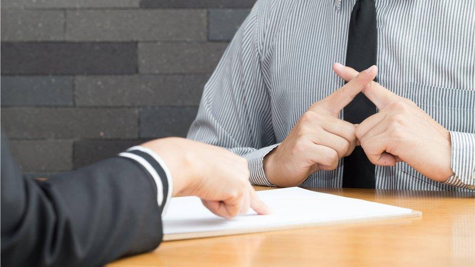 Probation officer and offender sitting at table