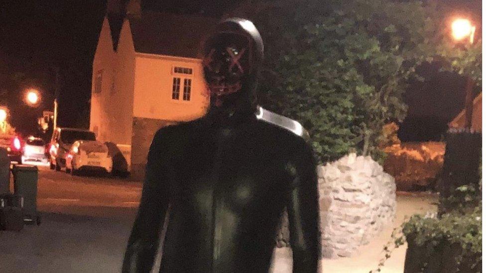 Man in gimp outfit