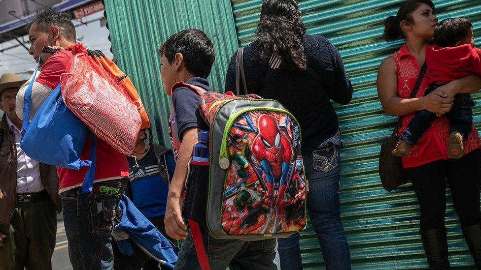 Families leave the airport in Guatemala City after arriving on an ICE deportation flight from the US on August 22, 2019