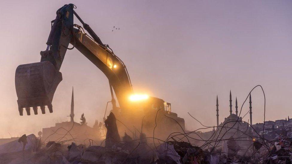 A digger seen in the rubble