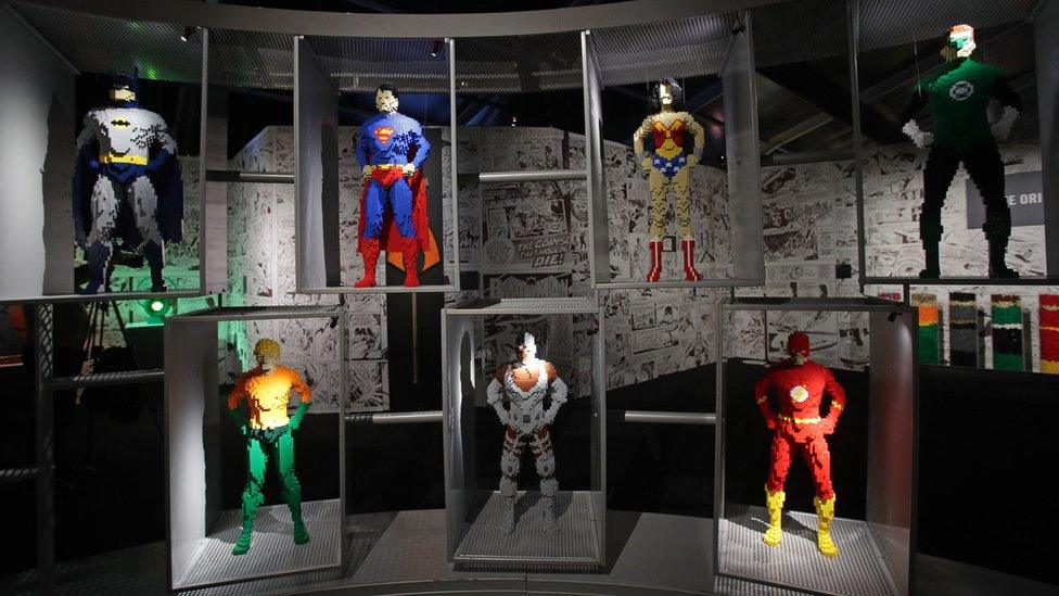 Models of various superheroes on display