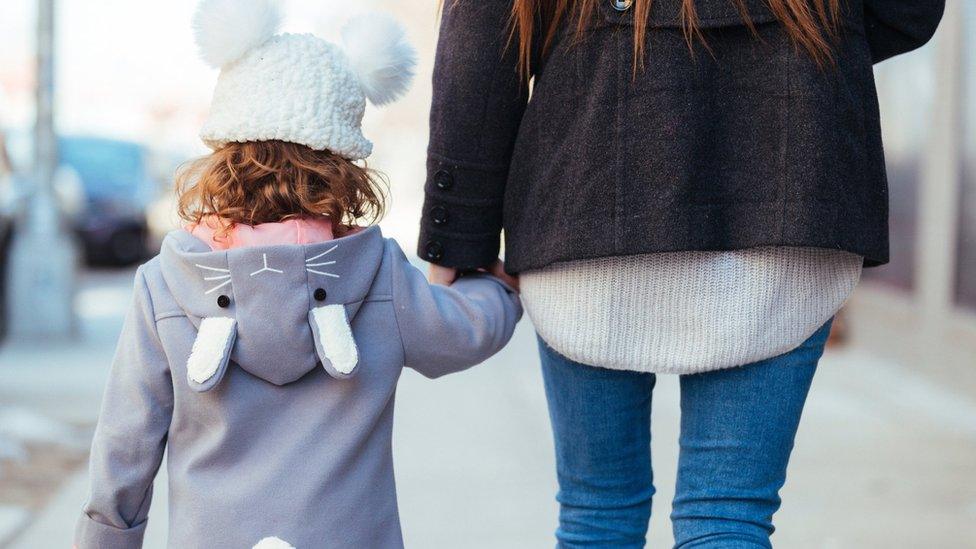 Mother and Daughter Walking together holding hands