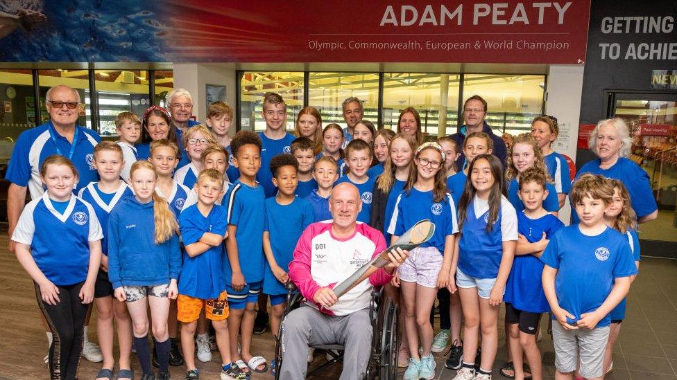 Glyn Bennett takes part in The Queen's Baton Relay as it visits Uttoxeter as part of the Birmingham 2022 Queens Baton Relay on July 20, 2022 in Uttoxeter,